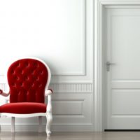 Burgundy chair in a white interior