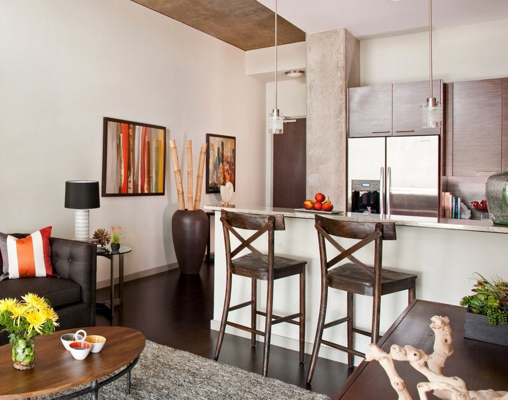 The interior of the kitchen-living room with a brown vase on the floor