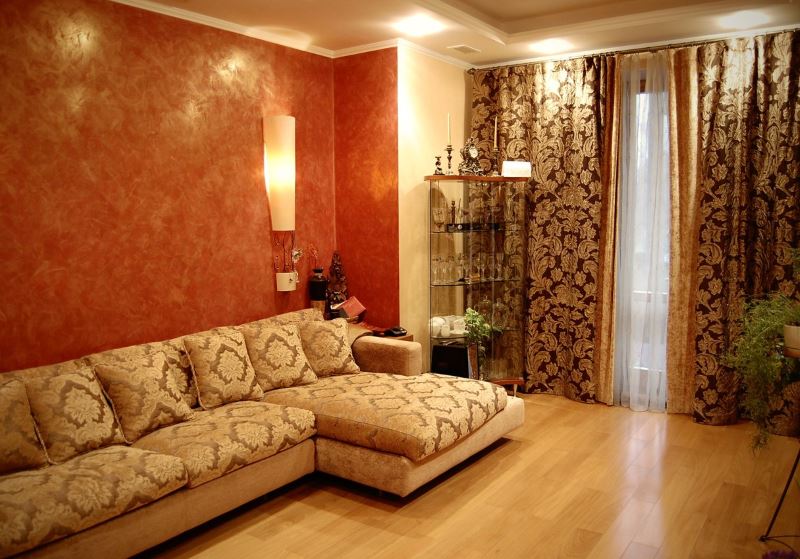 Curtains with golden patterns on the windows of the living room