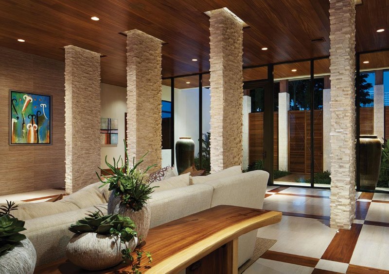 Zoning of the living room space with natural stone columns