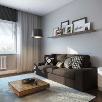 Wall decoration over the sofa with paintings and photographs