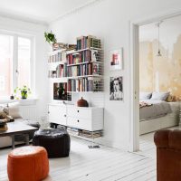 Books on open shelves in a white living room