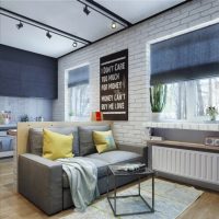 Gray sofa on a background of a white brick wall