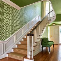 Staircase walls with green wallpaper