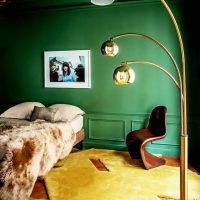 Light yellow carpet in the bedroom with a dark green wall