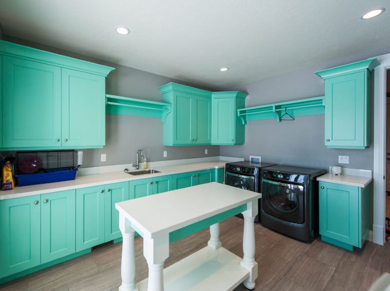 Green cabinets on gray walls