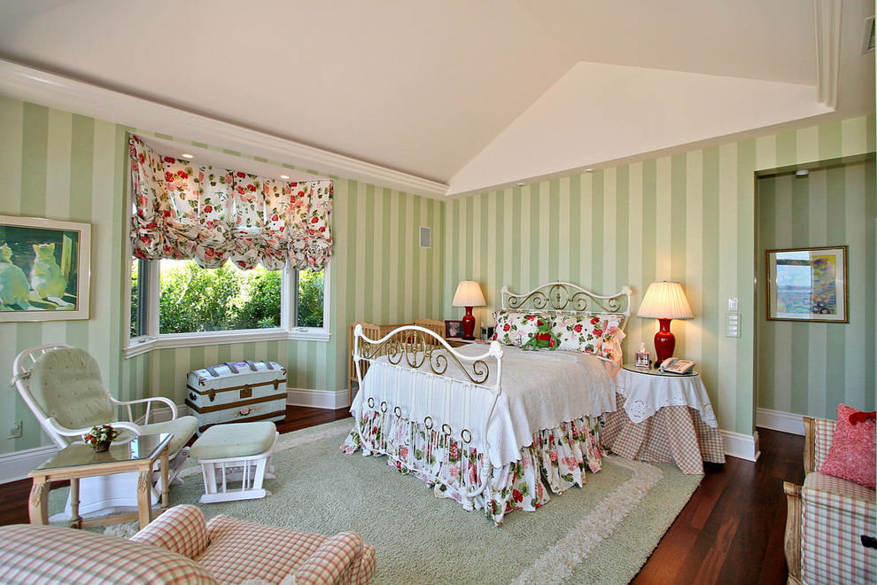 Bedroom with vertical striped green wallpaper.