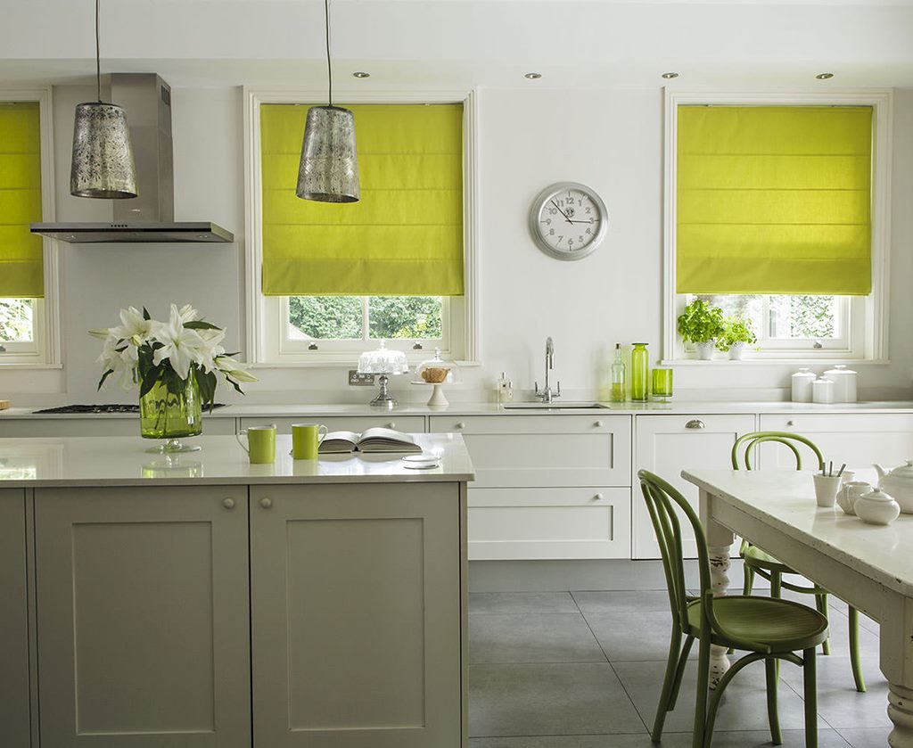 Light green curtains in the interior of the kitchen of a country house