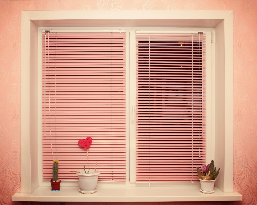 Window in an apartment with horizontal blinds