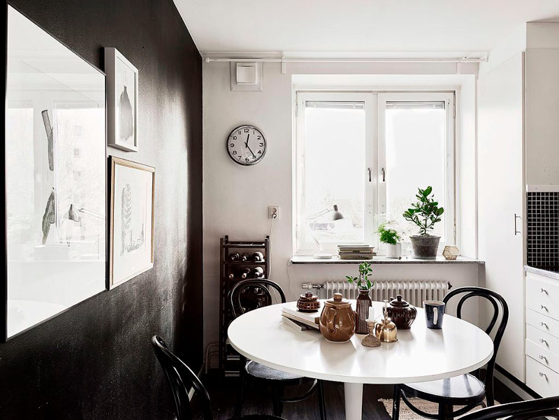 White dining table near the black wall