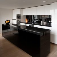 Black kitchen island on the brown floor