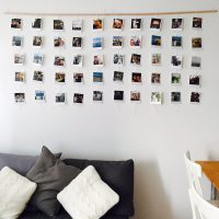 White wall with photos on a wooden plank