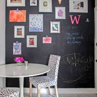 Slate wall with paintings and photographs