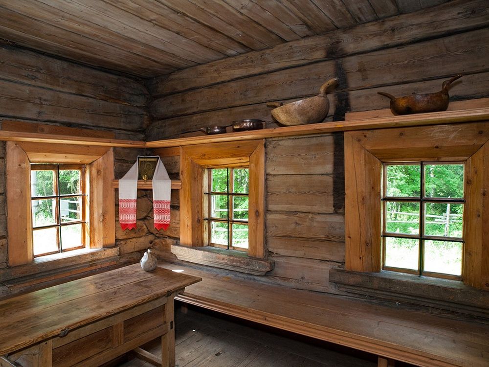 A long bench along a log wall in a Russian log hut