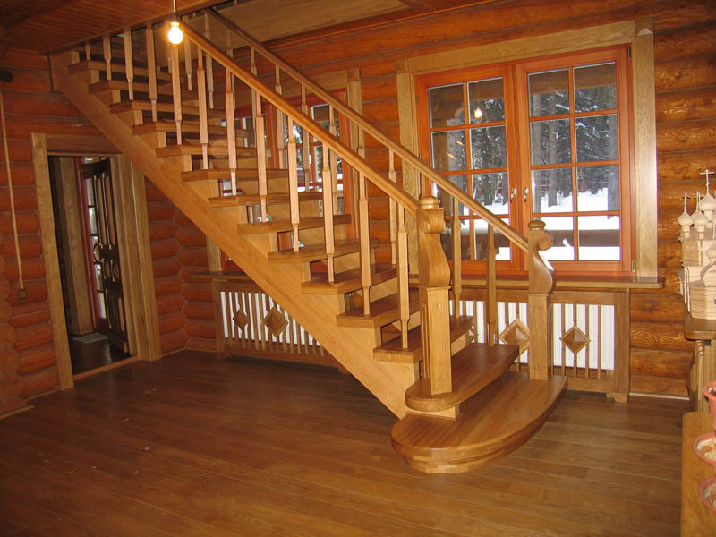 Attic wooden staircase in a log house