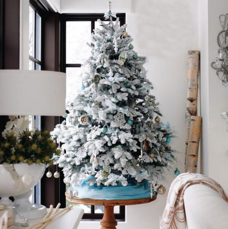 Small Christmas tree on a round wooden table