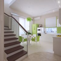 Green refrigerator in the kitchen in pastel colors