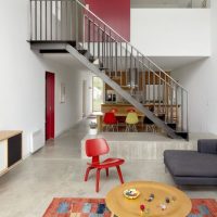 Red chair in front of a gray sofa