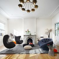 Chandelier with black shades in a white living room