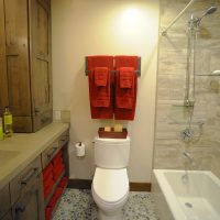 Burgundy towels on the bathroom wall