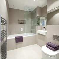 Lilac towel on the side of the acrylic bath