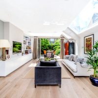 The interior of an elongated living room in a country house