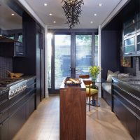 Bar counter in the middle of a long kitchen