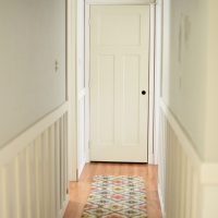 Beige door at the end of the hallway