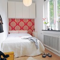 White bed in a narrow bedroom for a girl