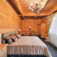 Black chandelier on a wooden ceiling