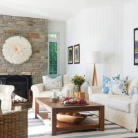 Fireplace with stone cladding in the living room of a private house