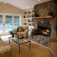 Upholstered furniture in front of a stone-clad fireplace