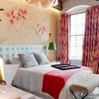 Red bedspread on a white bed