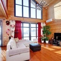 Red curtains on a window in a wooden house