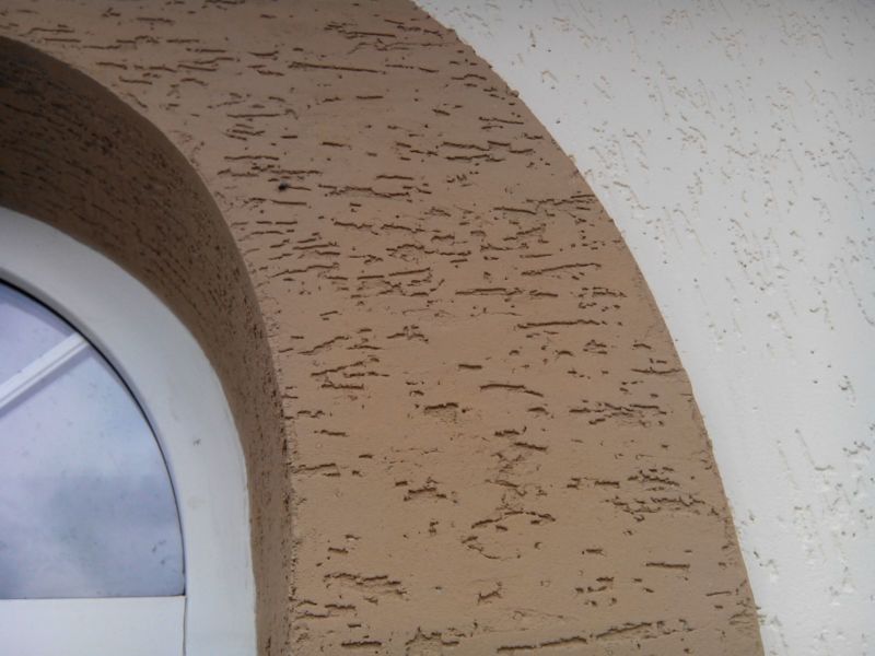 Brown arch on the outer wall of a country house