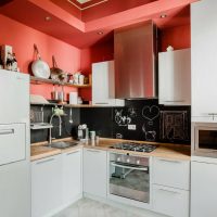 Red wall above the kitchen set