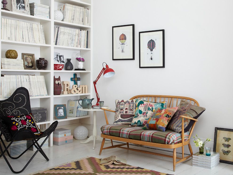 Wooden daybed with variegated pillows against a white wall