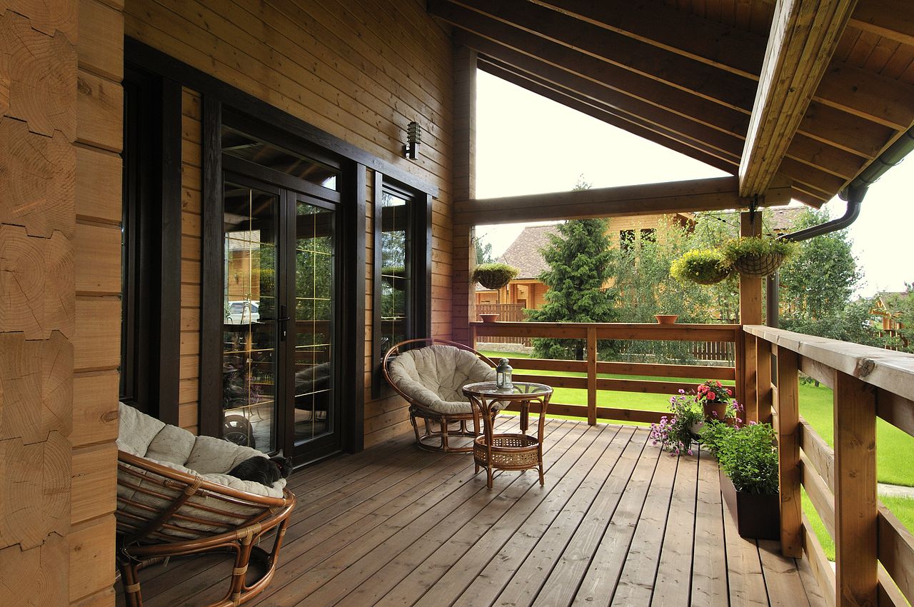 Two rattan chairs on the outdoor terrace of a country house