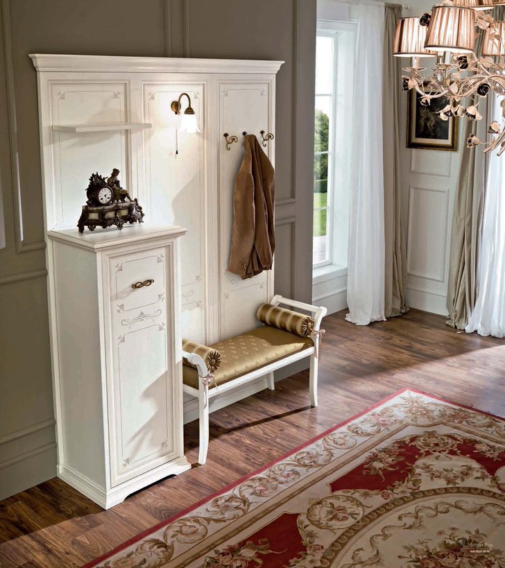 White hanger with sofa in the hallway of a rural house