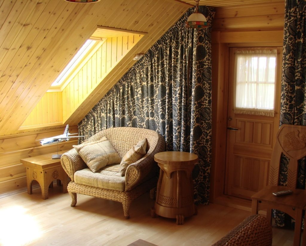 Armchair under the window in the attic of a private house