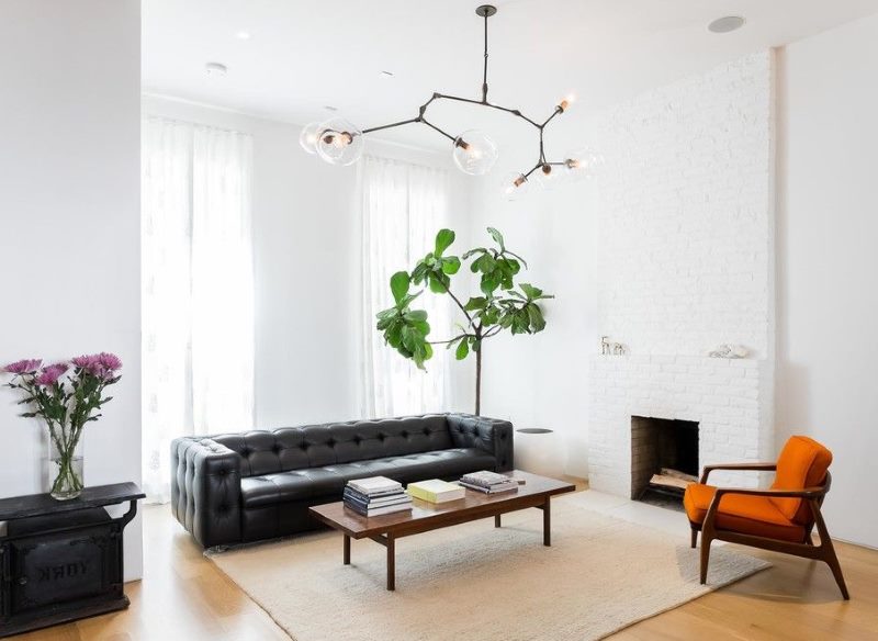 A contrasting combination of black furniture with white walls