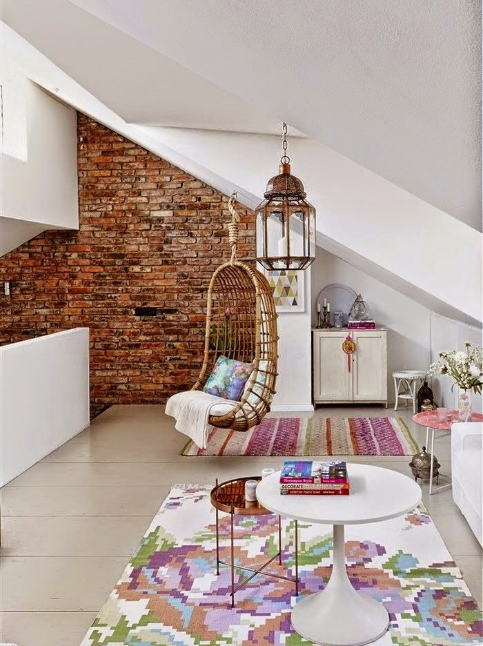 Hanging rattan chair in the attic of a private house