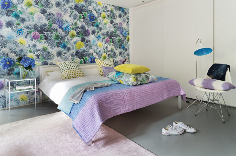 Bright wallpaper with colorful ornament on the wall of the bedroom of a panel house