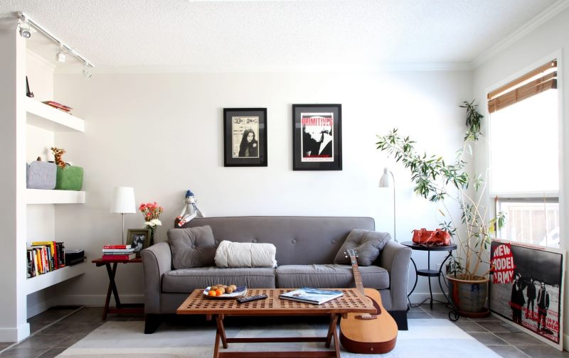 Gray sofa against the background of a white wall of the living room