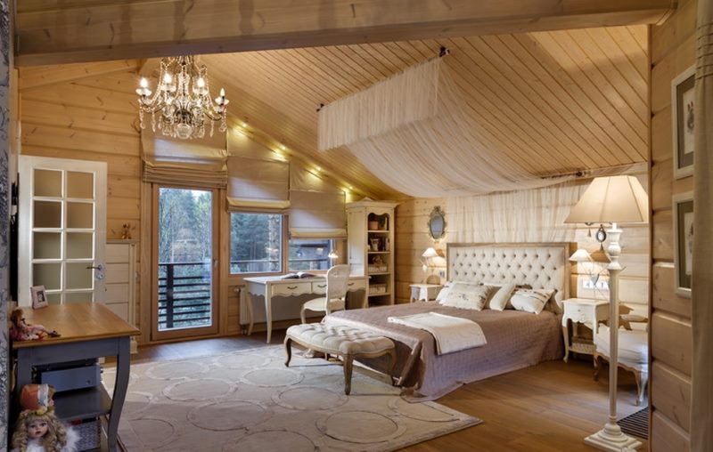 The interior of the bedroom in the attic of a house made of timber