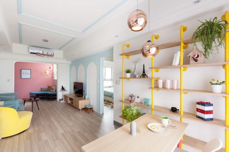 An open rack on pipe racks in the interior of a two-bedroom apartment