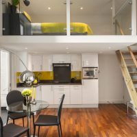 Bed on the mezzanine in a studio apartment