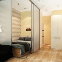 Bed behind sliding glass partitions