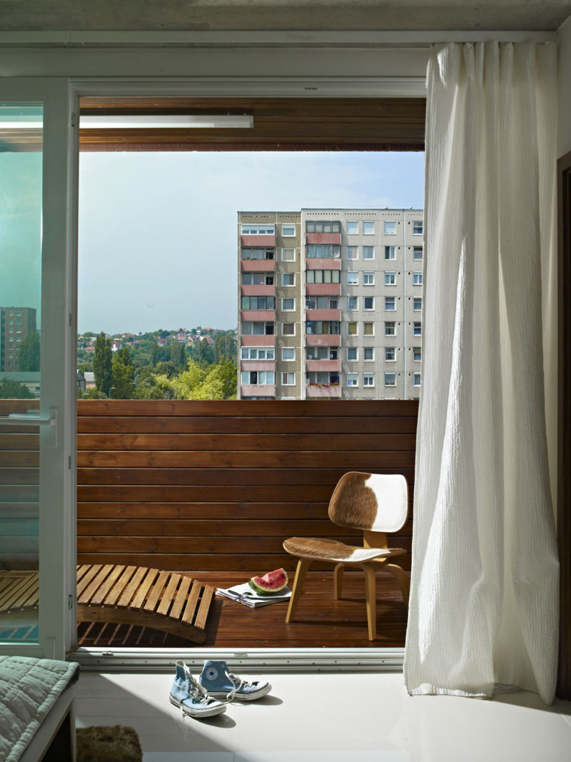 A small chair on the balcony in a two-bedroom apartment