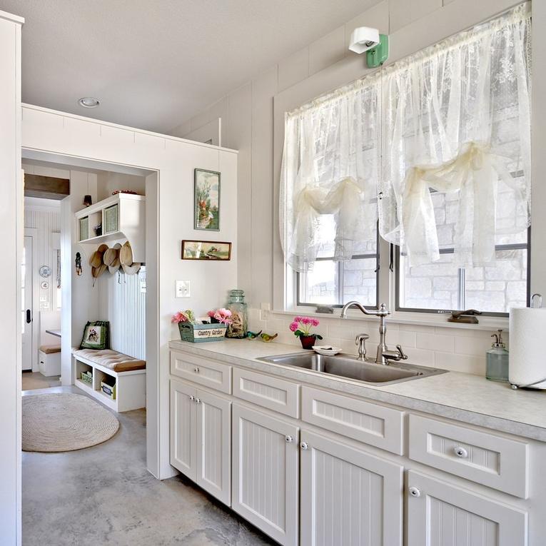 Sink under the window in the kitchen of a country house